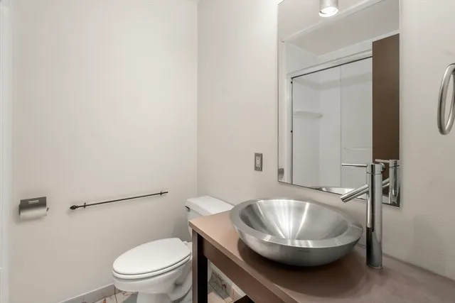 a bathroom with a toilet a sink and a mirror