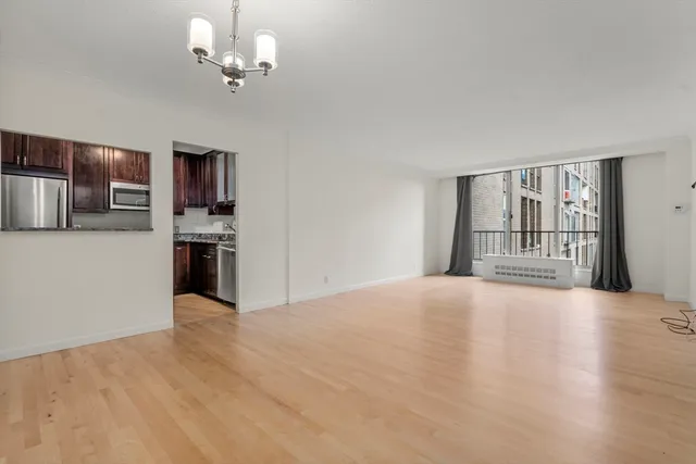 a view of an empty room with a kitchen