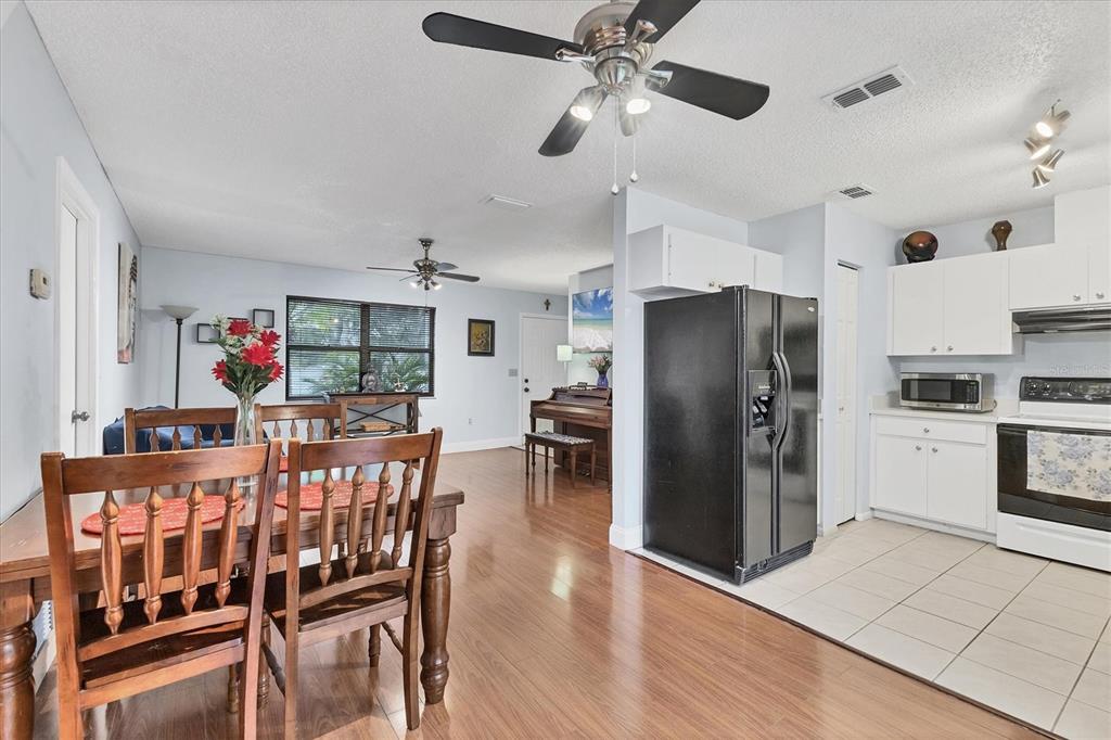 7109 Java Drive Sarasota, FL 34241 - Photo 11 of 23 a view of a dining room with furniture a kitchen and chandelier