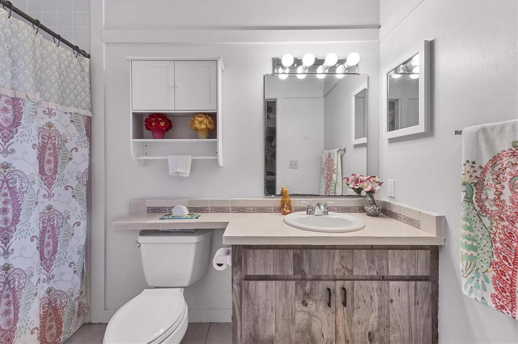 7109 Java Drive Sarasota, FL 34241 - Photo 14 of 23 a bathroom with a sink a toilet and a mirror