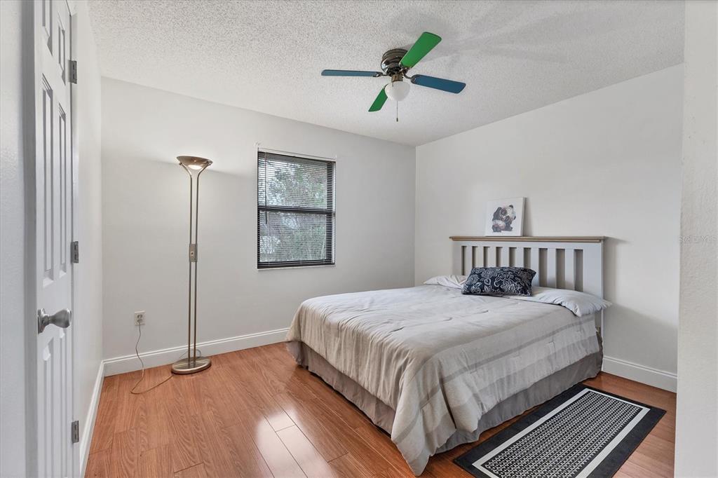 7109 Java Drive Sarasota, FL 34241 - Photo 18 of 23 a bedroom with a bed a window and a chandelier