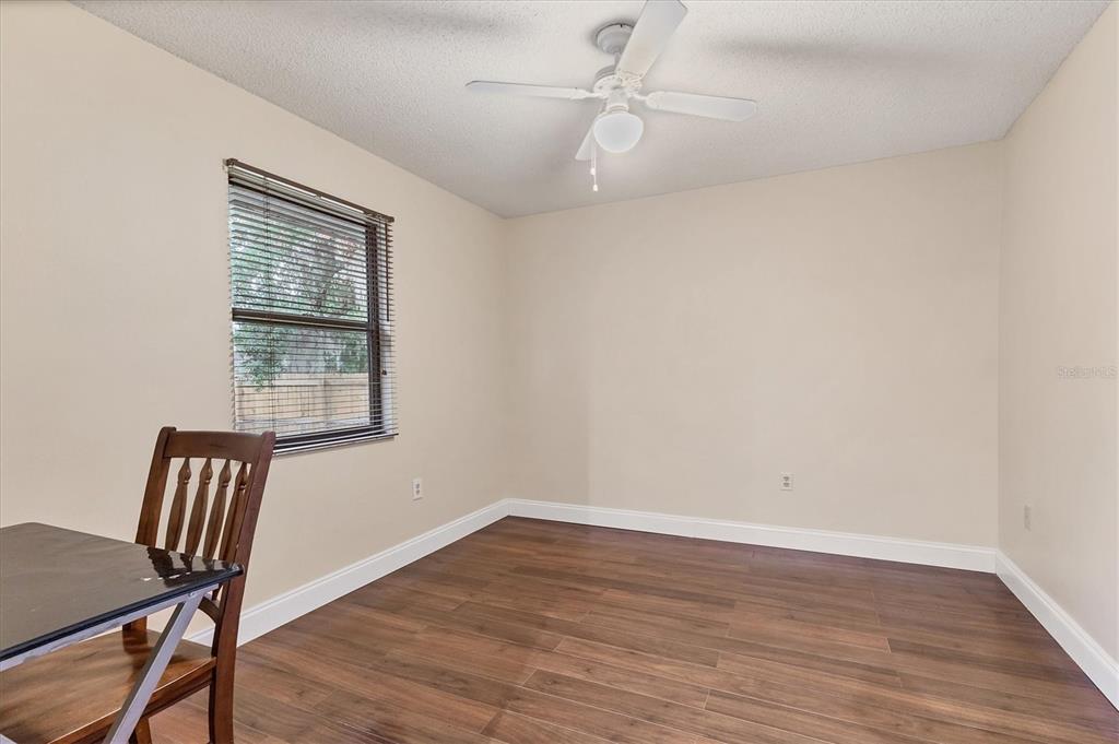7109 Java Drive Sarasota, FL 34241 - Photo 19 of 23 a view of a room with wooden floor a ceiling fan and windows