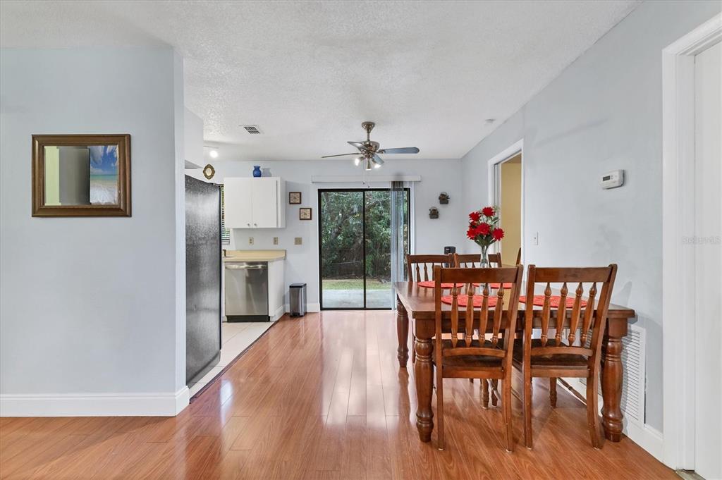 7109 Java Drive Sarasota, FL 34241 - Photo 8 of 23 a dining room with furniture window wooden floor and a rug