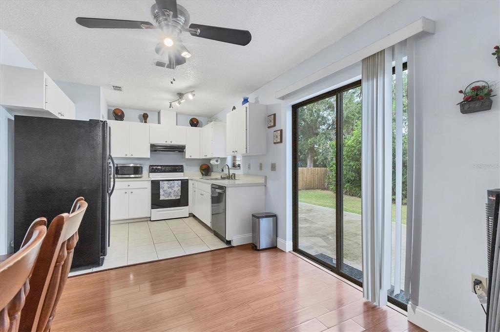 7109 Java Drive Sarasota, FL 34241 - Photo 9 of 23 a kitchen with stainless steel appliances granite countertop a stove top oven a sink and cabinets