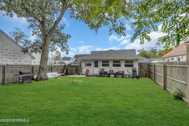 a front view of house with yard seating and green space