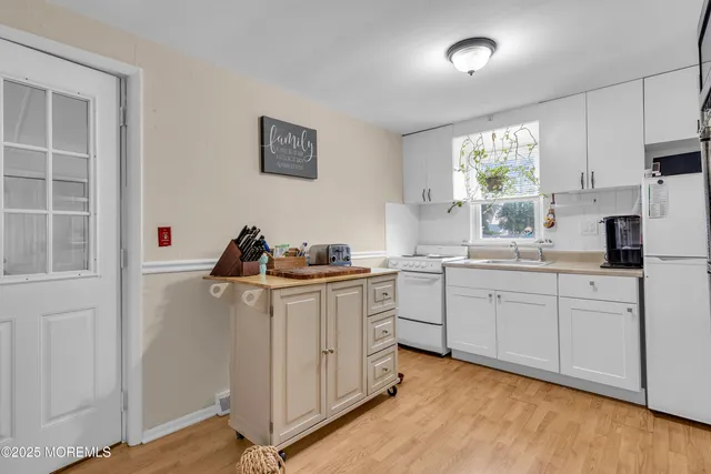 a kitchen with cabinets and window