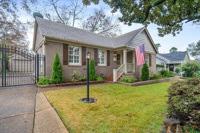 a front view of house with yard and green space