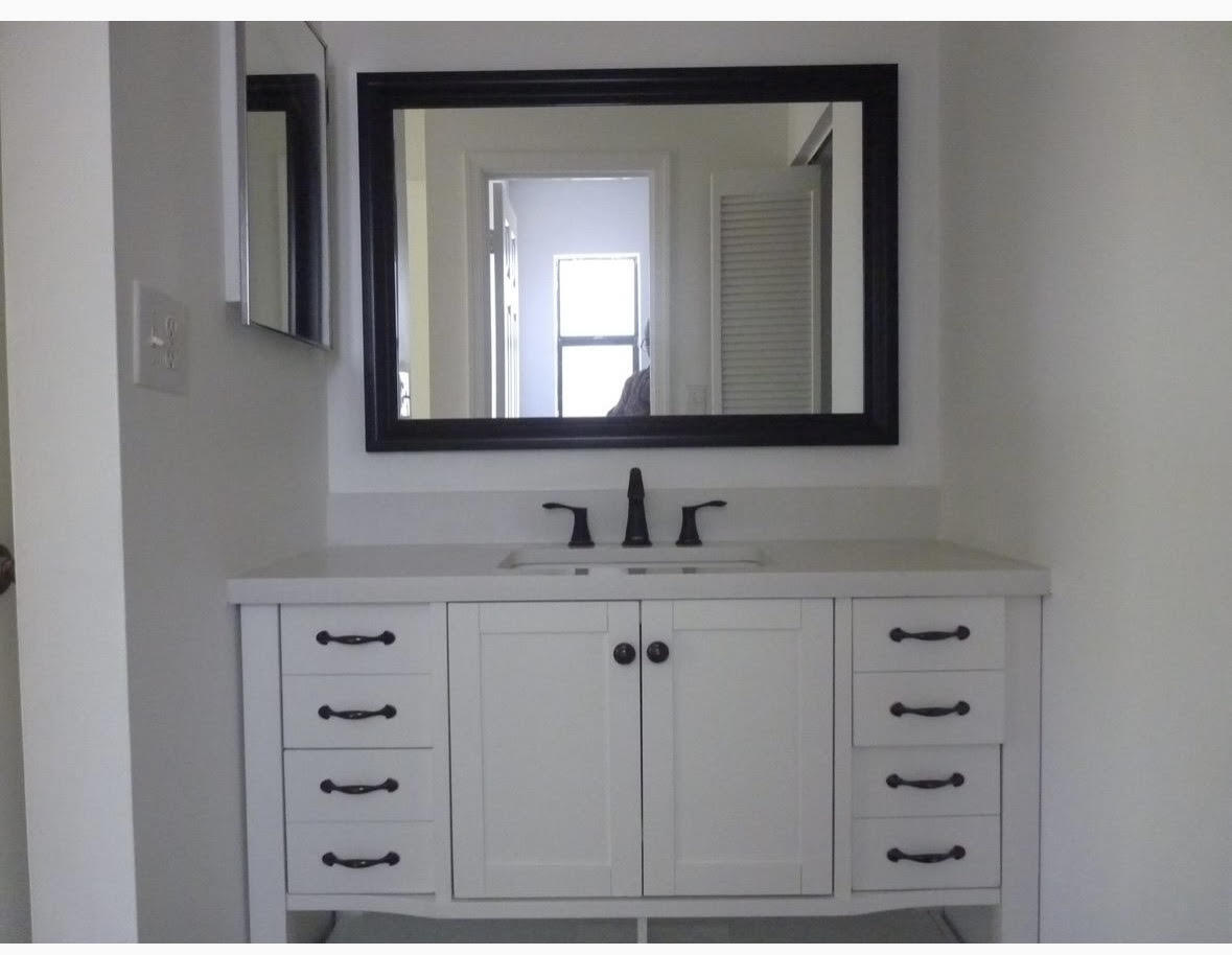 3130 Millwood Terrace, Unit 2120 Boca Raton, FL 33431 - Photo 12 of 15 a bathroom with mirror