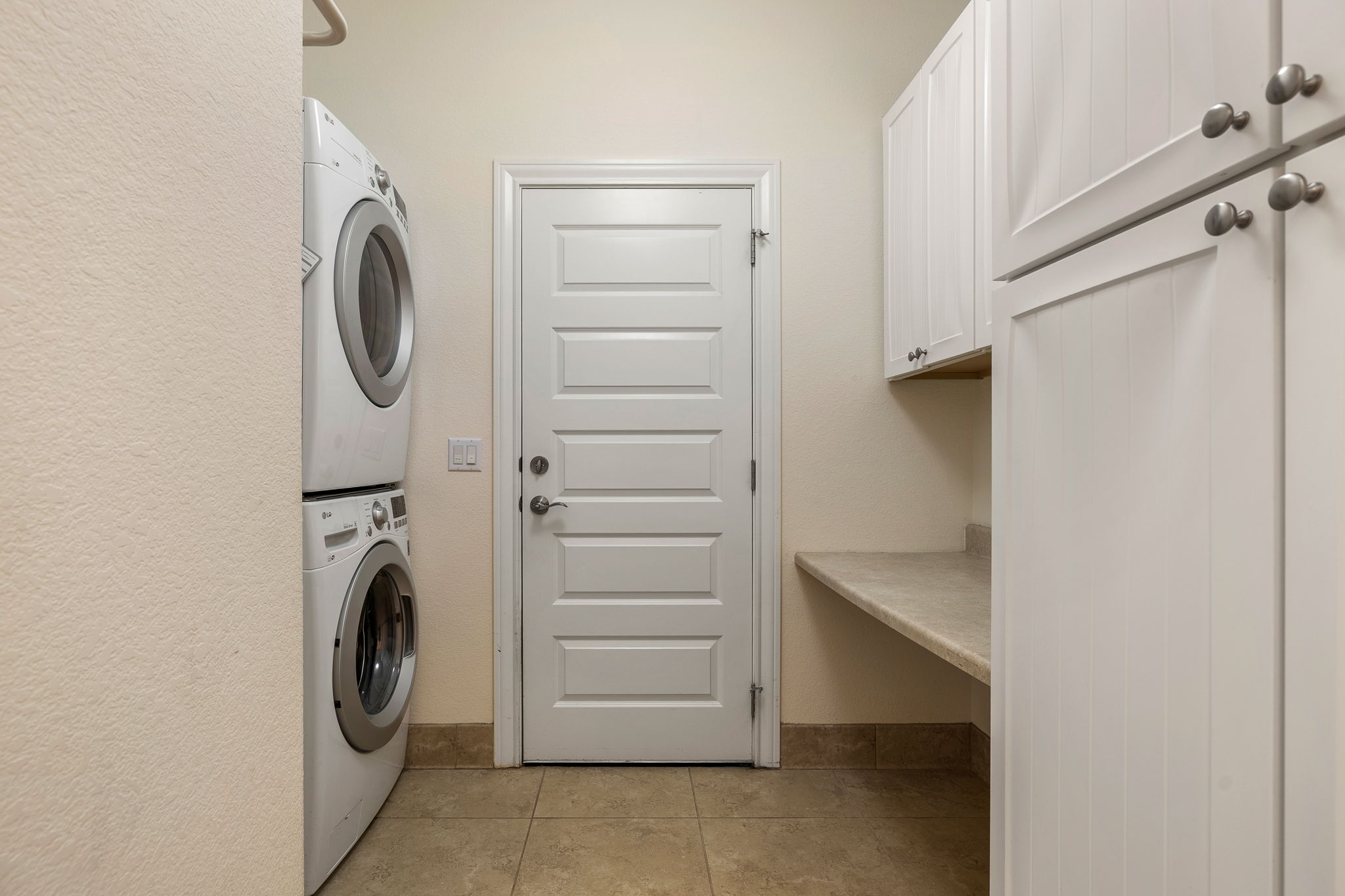 5201 Big Spring Street Georgetown, TX 78633 - Photo 20 of 26 Laundry room featuring stacked washer and clothes dryer and light tile patterned floors