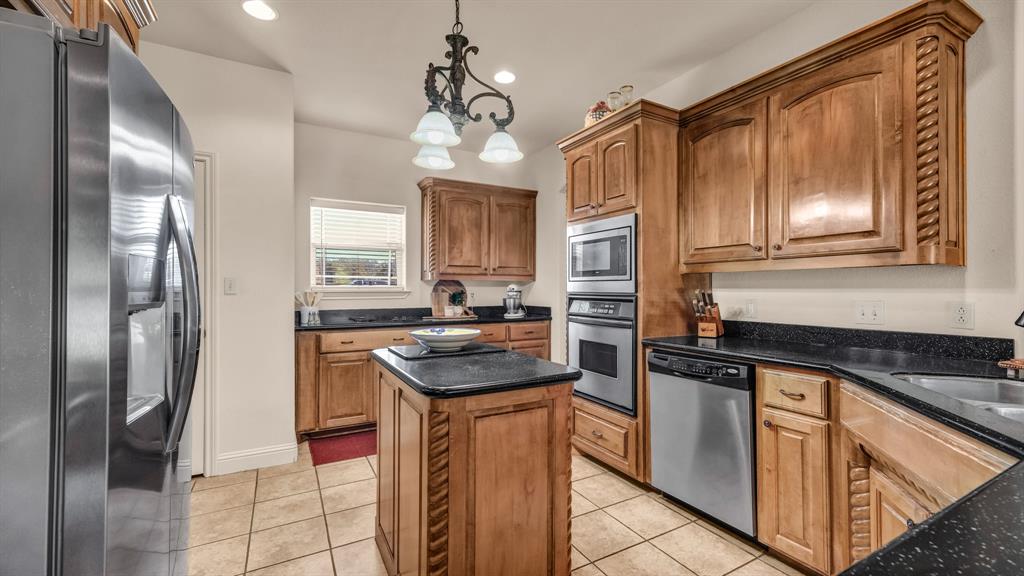 1144 B Boling Ranch North Road Azle, TX 76020 - Photo 29 of 40 a kitchen with granite countertop stainless steel appliances a sink stove and refrigerator