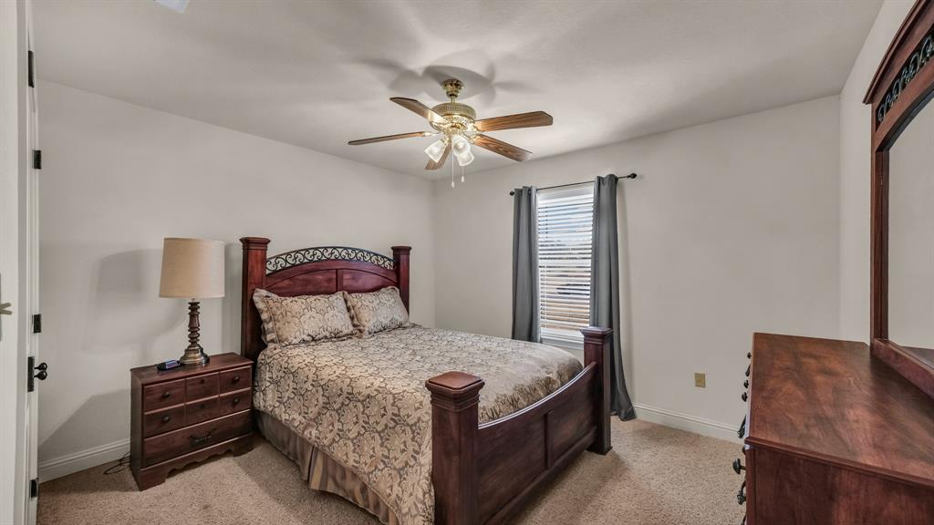 1144 B Boling Ranch North Road Azle, TX 76020 - Photo 33 of 40 a bedroom with a bed and a chandelier