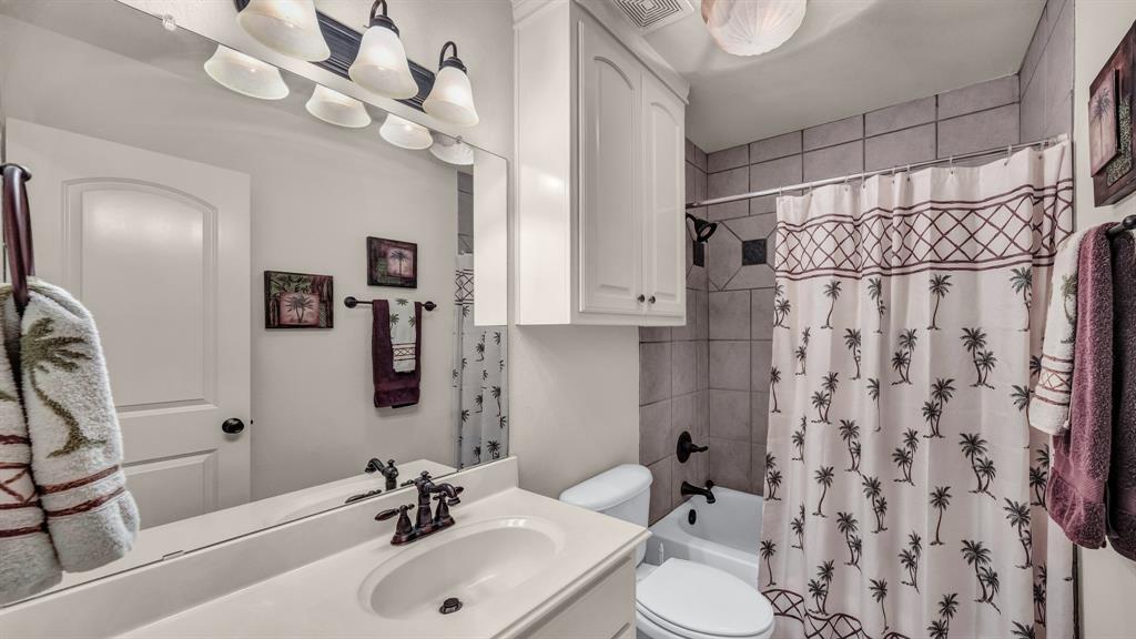 1144 B Boling Ranch North Road Azle, TX 76020 - Photo 34 of 40 a bathroom with a sink a toilet and a mirror