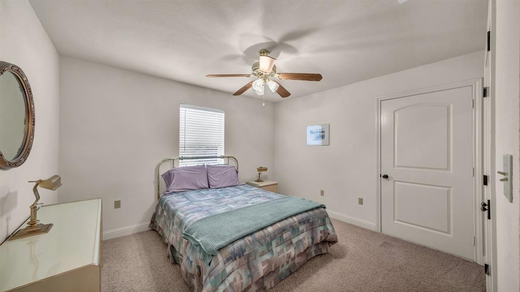 1144 B Boling Ranch North Road Azle, TX 76020 - Photo 35 of 40 a bedroom with a bed and a chandelier