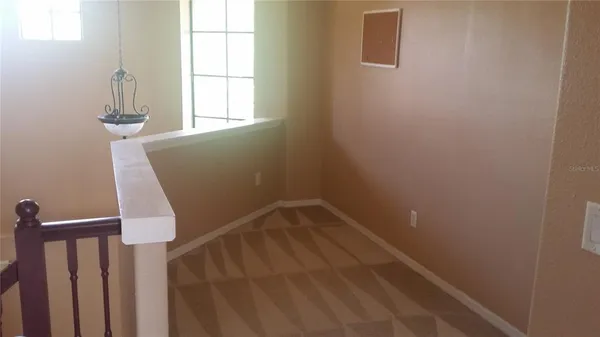 a view of storage and utility room with windows