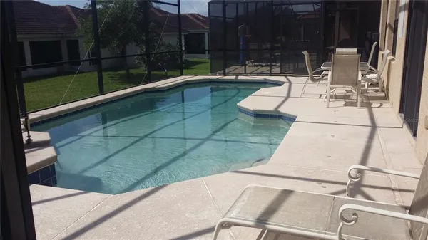 a view of swimming pool with seating space