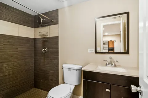 a bathroom with a sink toilet and shower