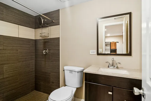 a bathroom with a sink toilet and shower