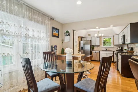 a view of a dining room with furniture and wooden floor