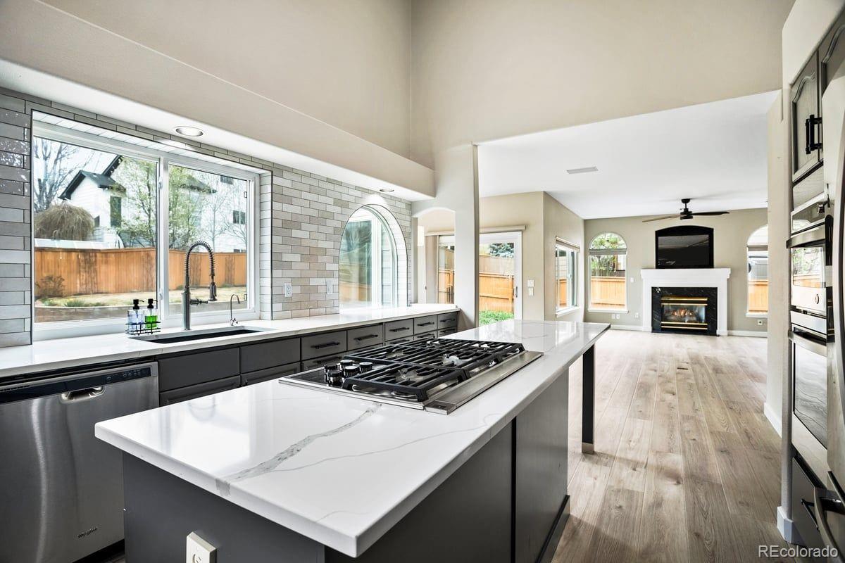 3385 White Oak Lane Highlands Ranch, CO 80129 - Photo 11 of 36 a kitchen with a stove a sink and a refrigerator