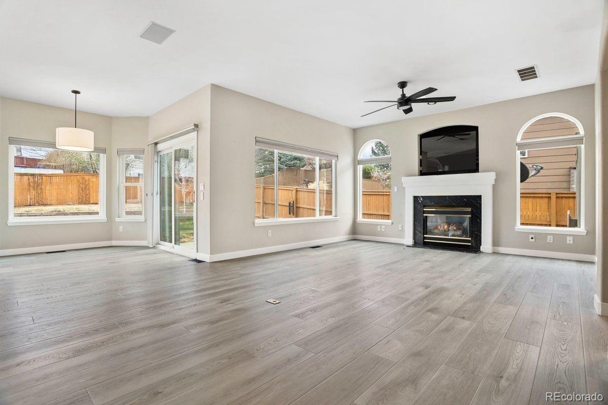 3385 White Oak Lane Highlands Ranch, CO 80129 - Photo 13 of 36 a view of an empty room with a fireplace and a window