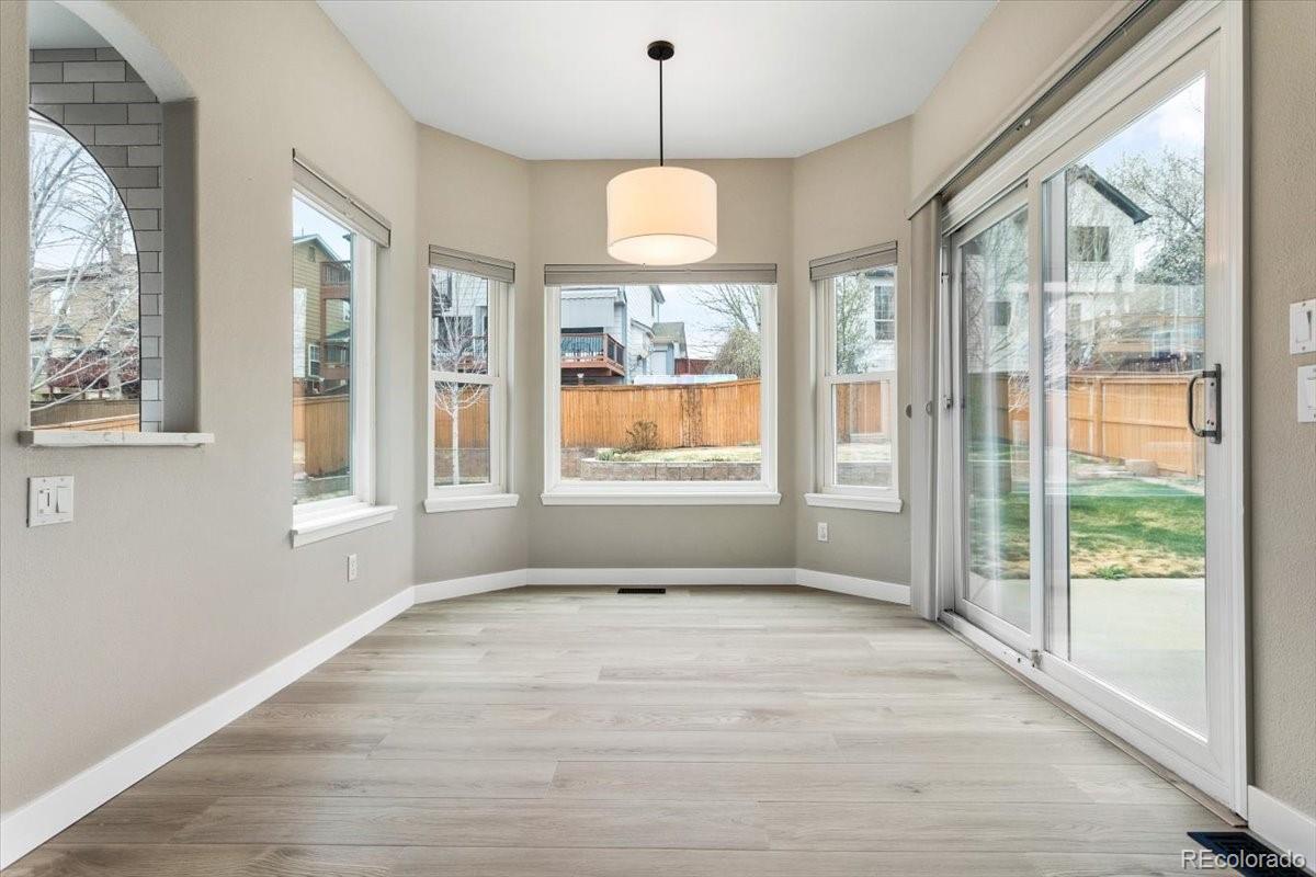3385 White Oak Lane Highlands Ranch, CO 80129 - Photo 14 of 36 a view of an empty room with a window and wooden floor