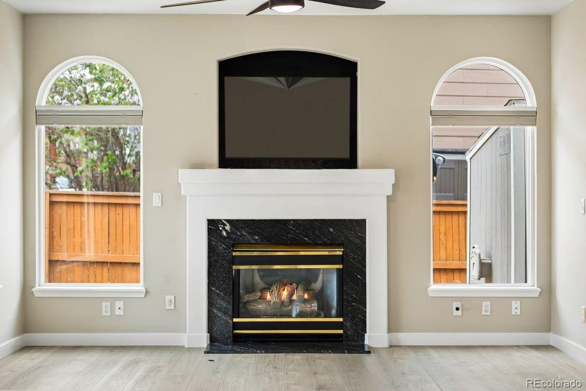 3385 White Oak Lane Highlands Ranch, CO 80129 - Photo 17 of 36 a living room with a fireplace and a window