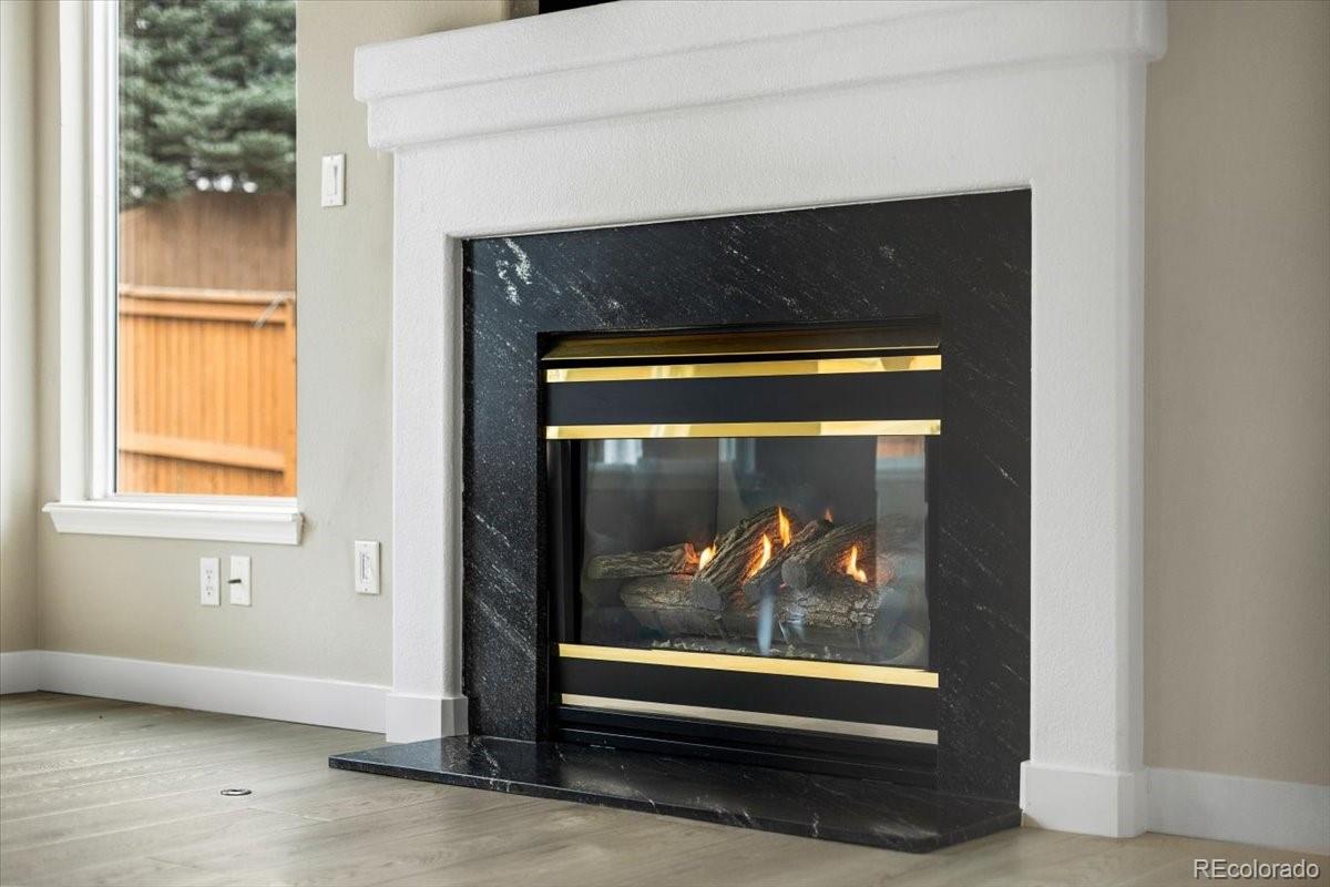 3385 White Oak Lane Highlands Ranch, CO 80129 - Photo 18 of 36 a view of an empty room with wooden floor and a fireplace