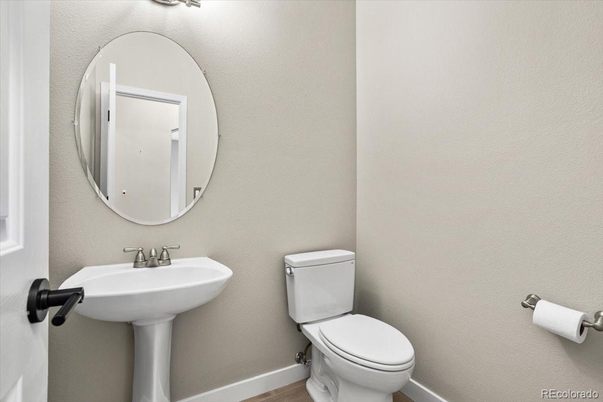 3385 White Oak Lane Highlands Ranch, CO 80129 - Photo 19 of 36 a bathroom with a toilet sink and mirror