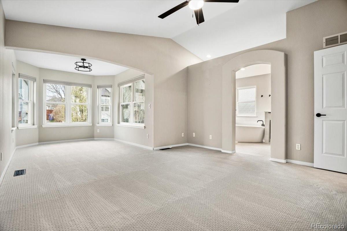 3385 White Oak Lane Highlands Ranch, CO 80129 - Photo 22 of 36 a view of an empty room with a window and a kitchen