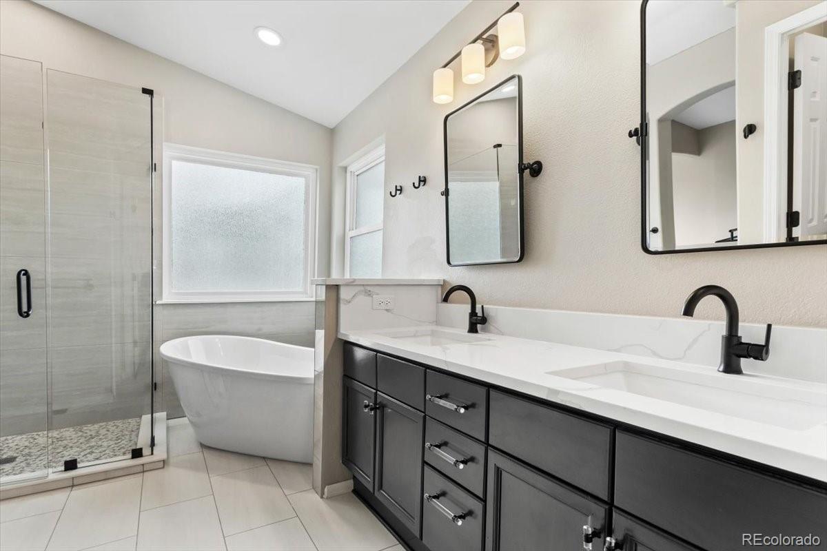 3385 White Oak Lane Highlands Ranch, CO 80129 - Photo 24 of 36 a bathroom with a double vanity sink mirror and bathtub