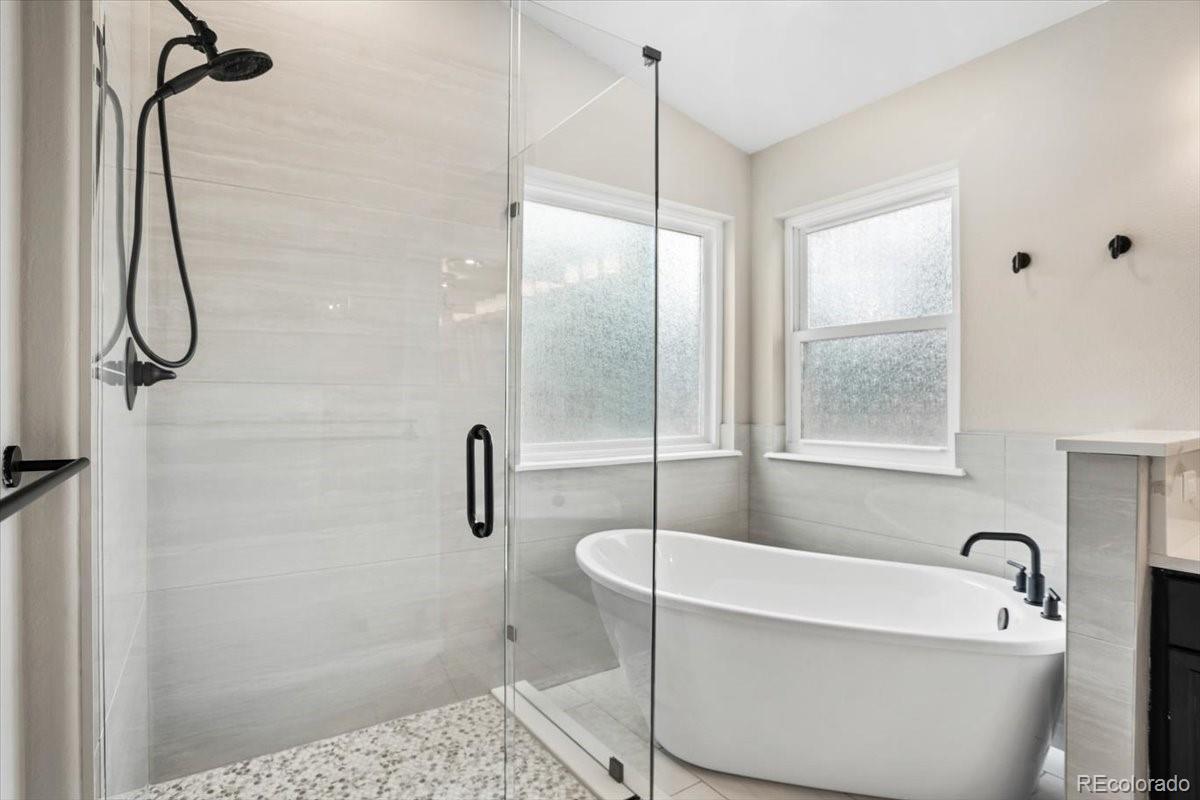 3385 White Oak Lane Highlands Ranch, CO 80129 - Photo 25 of 36 a bathroom with a white bath tub sitting next to a window
