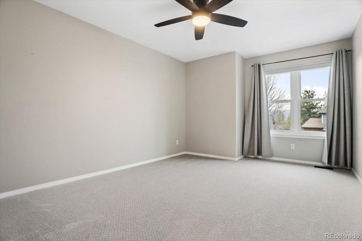 3385 White Oak Lane Highlands Ranch, CO 80129 - Photo 28 of 36 an empty room with windows and fan