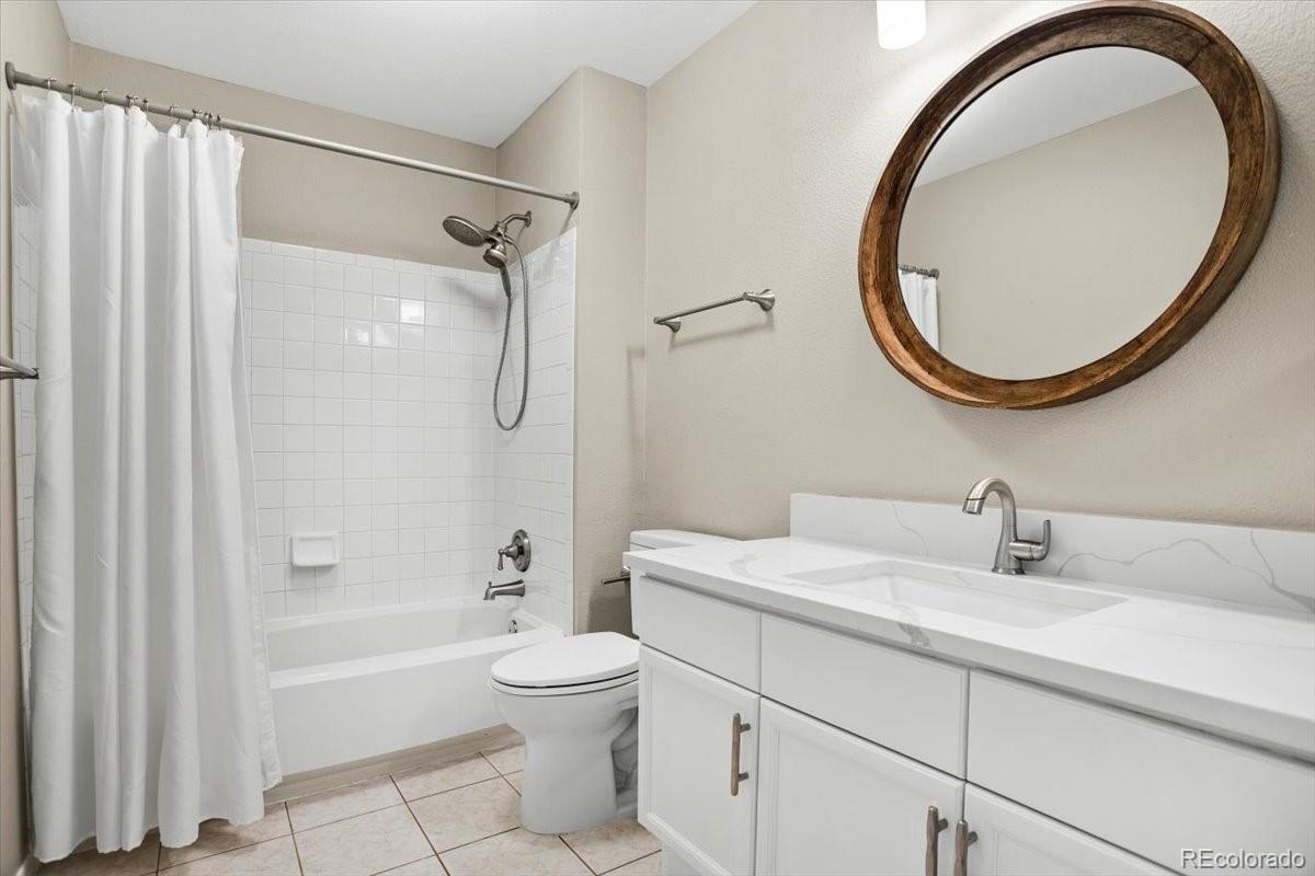 3385 White Oak Lane Highlands Ranch, CO 80129 - Photo 29 of 36 a bathroom with a sink a toilet and a mirror