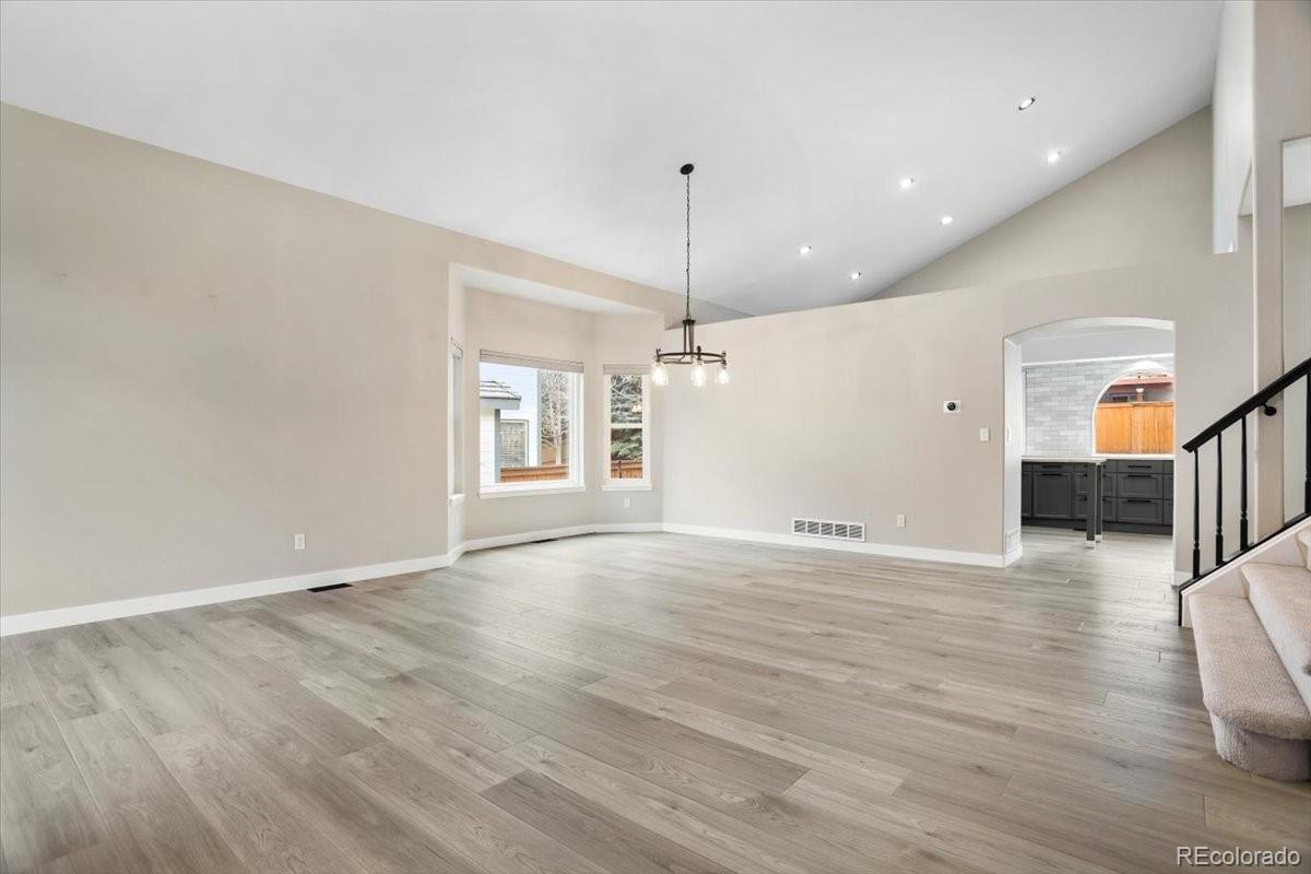 3385 White Oak Lane Highlands Ranch, CO 80129 - Photo 3 of 36 an empty room with wooden floor and windows
