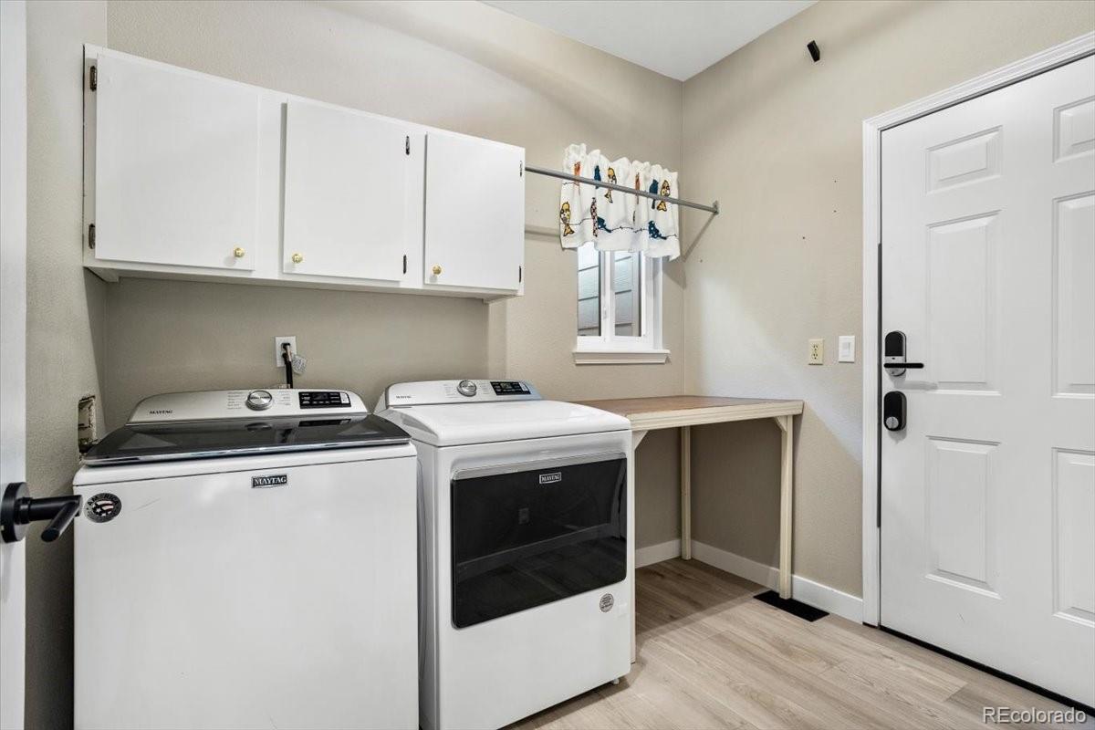 3385 White Oak Lane Highlands Ranch, CO 80129 - Photo 31 of 36 a view of a storage and utility room with washer and dryer