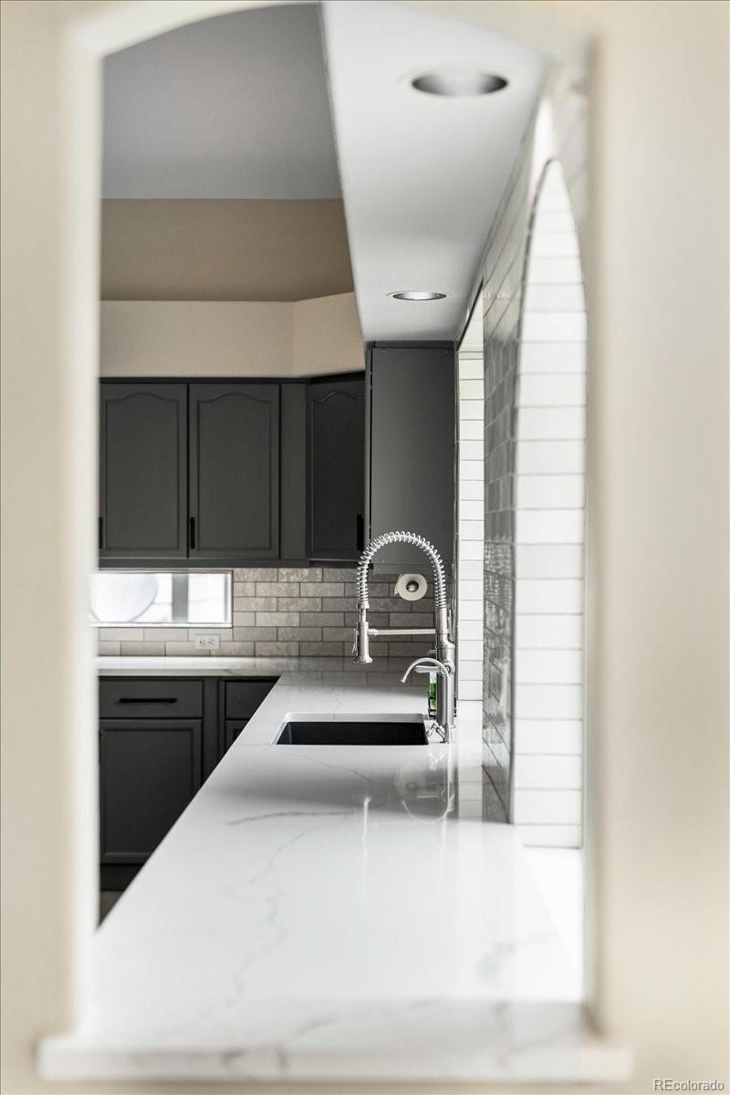 3385 White Oak Lane Highlands Ranch, CO 80129 - Photo 10 of 36 a kitchen with a sink and a refrigerator
