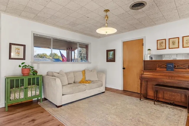 a living room with furniture and a chandelier