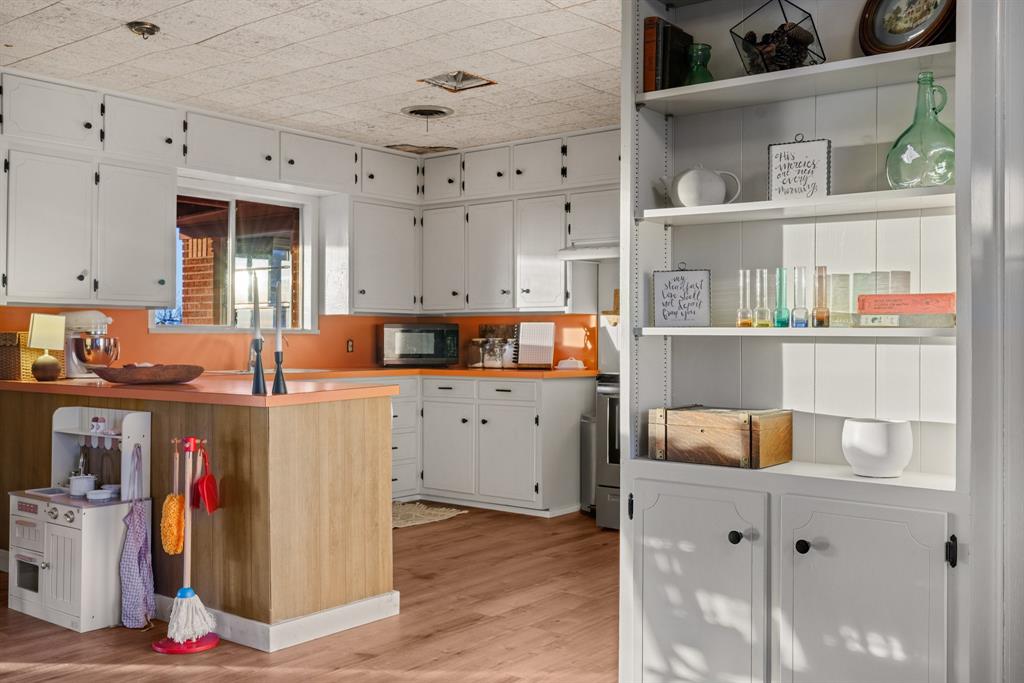 910 South Harrison Street West, TX 76691 - Photo 14 of 39 a room with cabinets and wooden floor