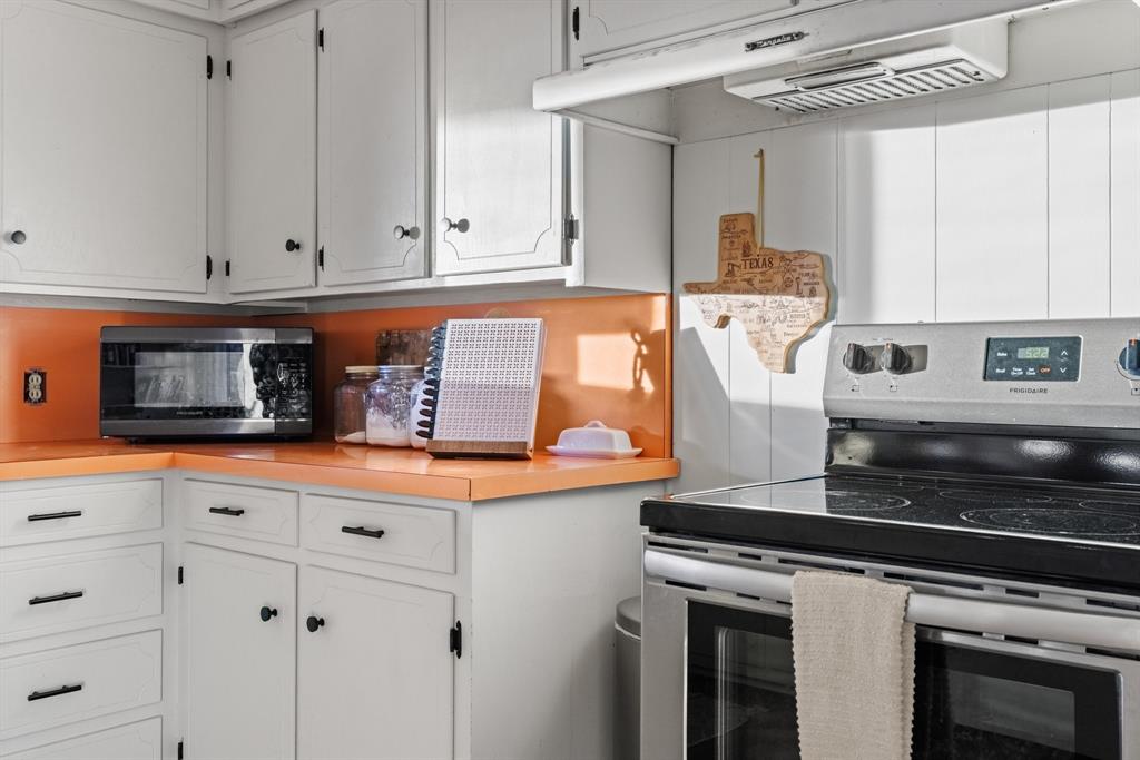 910 South Harrison Street West, TX 76691 - Photo 16 of 39 a kitchen with stainless steel appliances granite countertop a stove and a microwave
