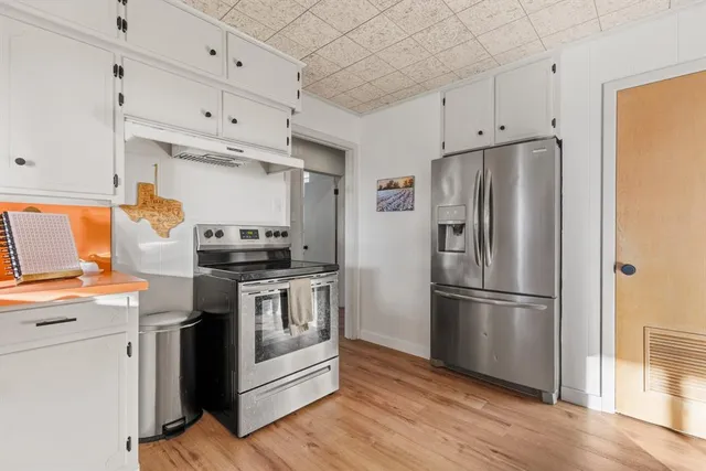 a kitchen with stainless steel appliances a refrigerator sink and microwave