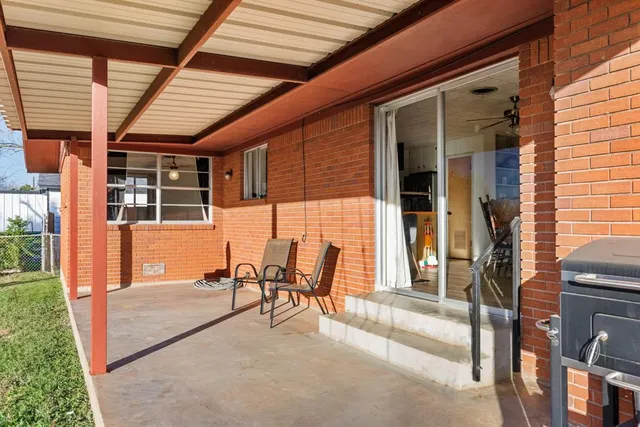 a view of a porch with chairs and backyard