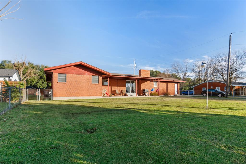 910 South Harrison Street West, TX 76691 - Photo 30 of 39 a front view of a house with a yard table and chairs