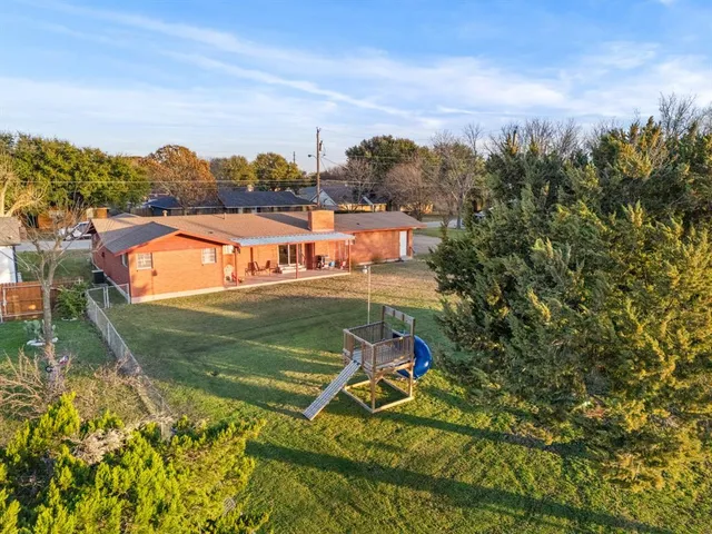 an aerial view of a house with a big yard