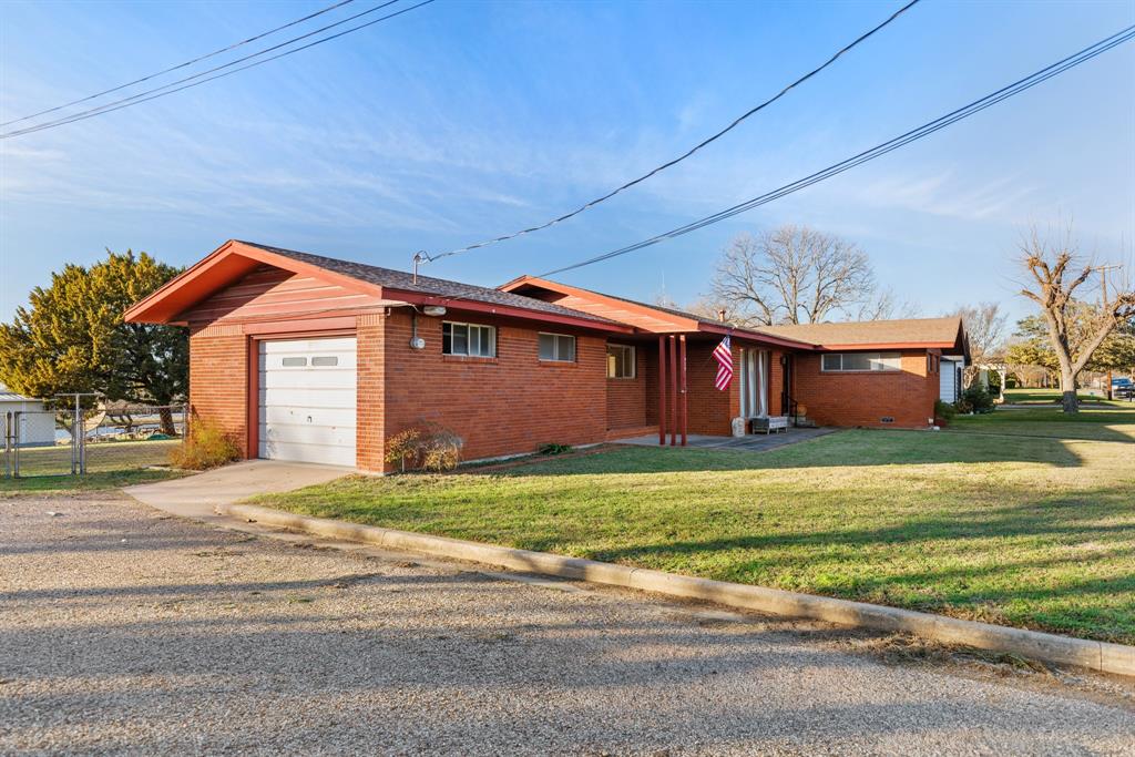 910 South Harrison Street West, TX 76691 - Photo 4 of 39 a front view of a house with a yard and garage