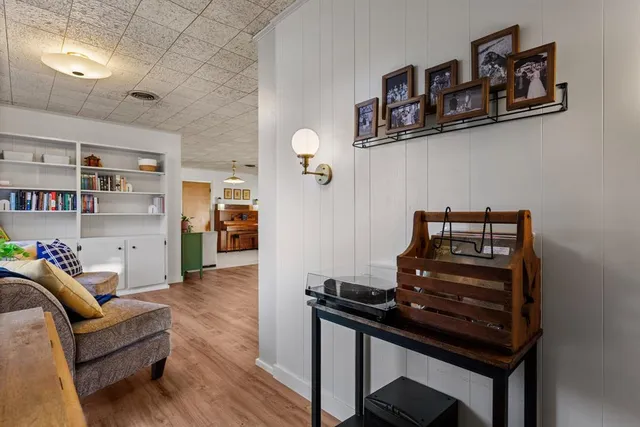a living room with furniture and a piano