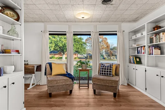 a living room with furniture and a book shelf