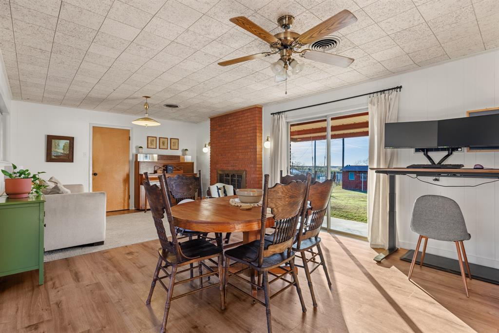 910 South Harrison Street West, TX 76691 - Photo 10 of 39 a dining room with furniture a floor to ceiling window and a flat screen tv
