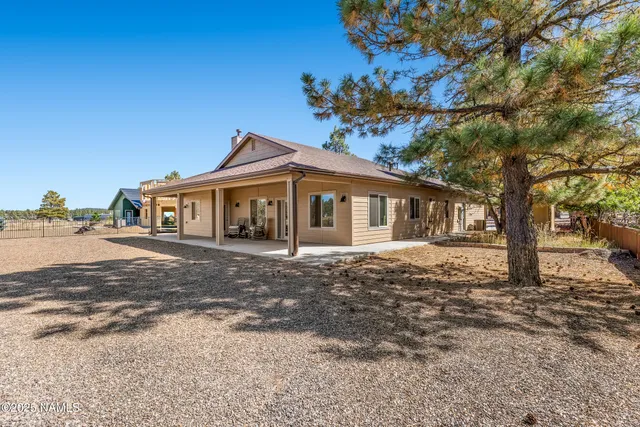 a front view of a house with a tree in it