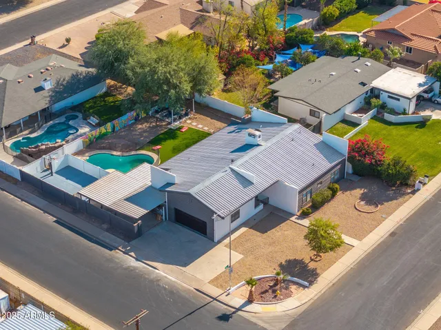 an aerial view of a house with a swimming pool patio and outdoor seating