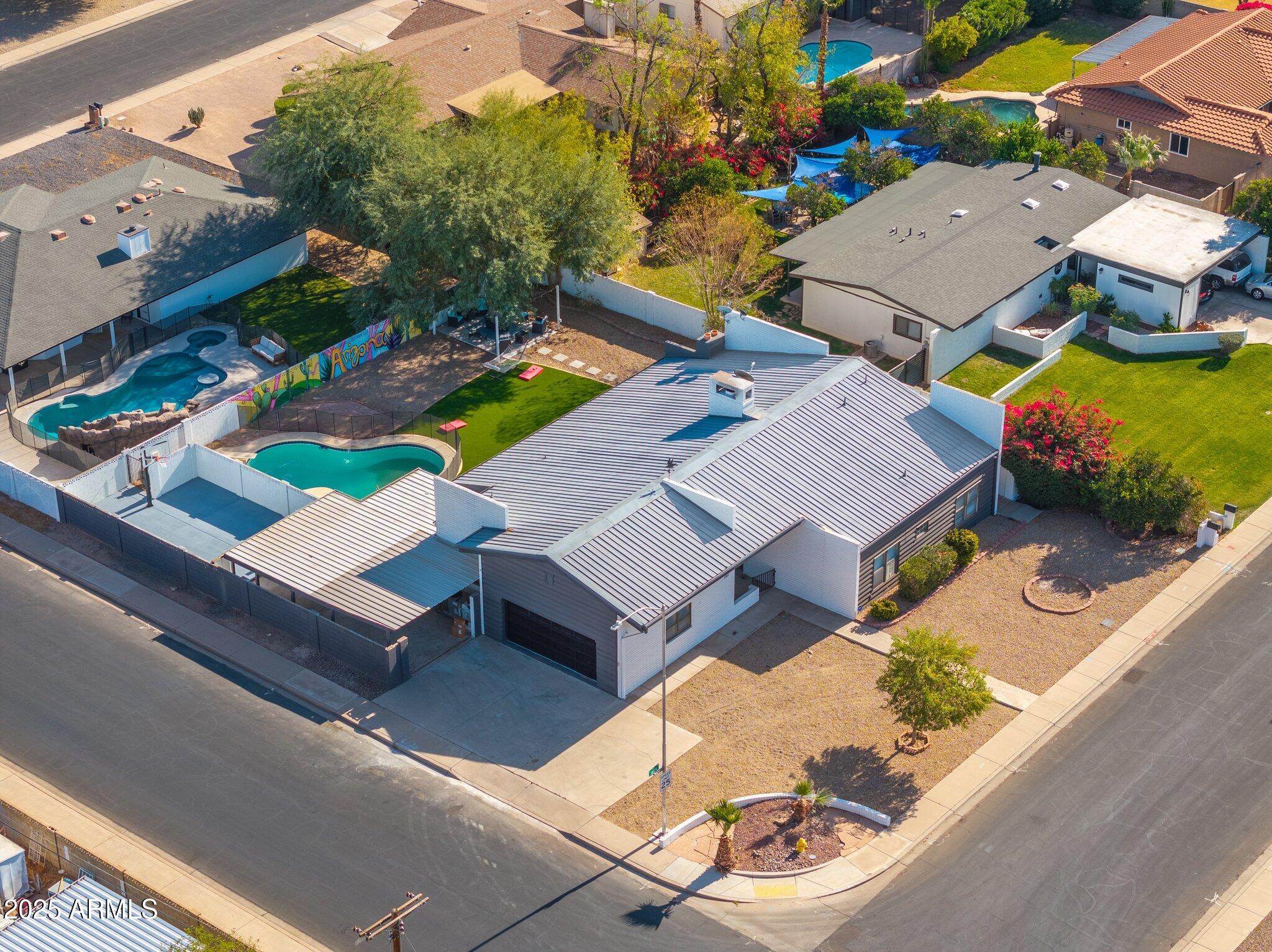 an aerial view of a house with a swimming pool patio and outdoor seating